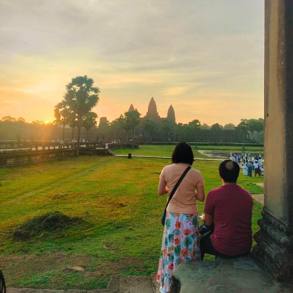2 days in Siem Reap tour with sunrise at Angkor Wat, early morning sky, temple reflection, and small group guests at the main viewing area