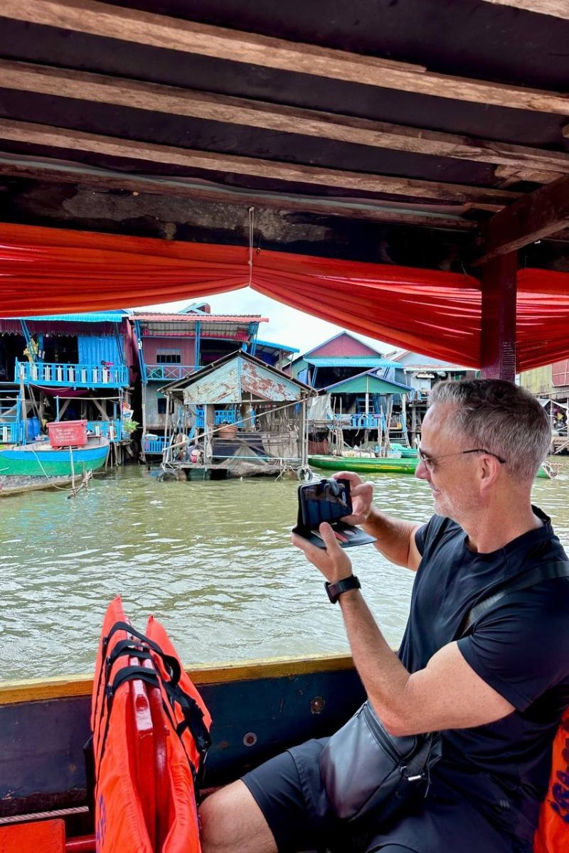 Kulen Mountain and Kampong Pluk Floating Village tour on the boat taking photos