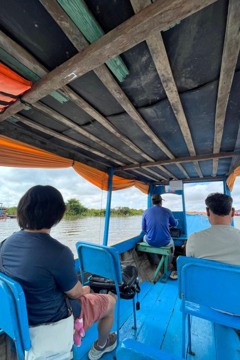 Local boat captain steering the Private Driver Service to Bakong and Rolous Temples with Kampong Phluk Floating Village cruise on Tonle Sap